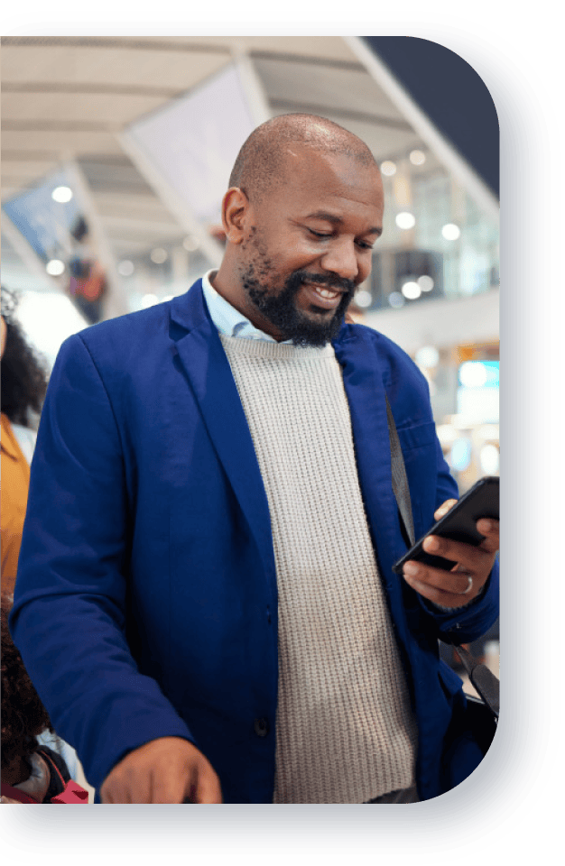 Man booking a Brooklyn car service ride using the Brothers Car Service app at a transportation hub.